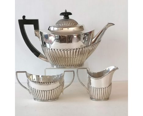 An Edwardian three-piece silver tea service with embossed half-fluted and reeded decoration by Mappin &amp; Webb, Sheffield, 