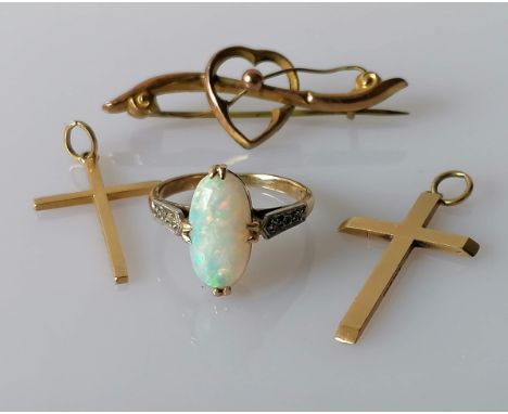 A cabochon opal ring, 9 x 7mm, on a gold claw setting, size N; a heart brooch, both stamped, and two crucifix pendants, hallm