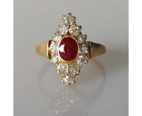 An oval ruby ring set with old-cut diamonds in a yellow gold claw setting, the faceted ruby measuring an estimated 0.80 carat