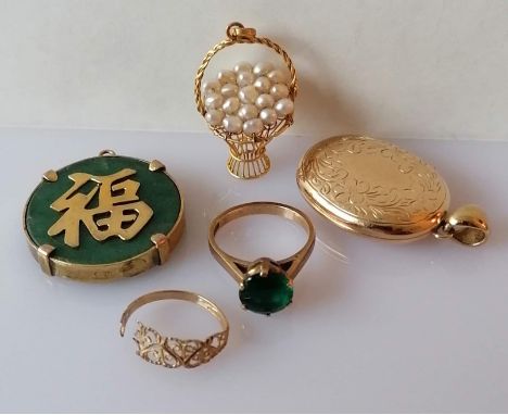 A gold oval locket with etched decoration, 30 x 24mm; a pierced gold ring, damaged, both hallmarked 9ct; a gem-set gold ring 