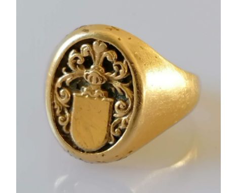 A yellow gold signet ring with an oval armorial crest, possibly Italian, stamped 750 and tests for 18ct gold, size T, 11.7g