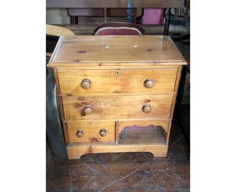 A 20th century pine chest of drawers, two long over one short drawers along with an arch shelf, raised on a plinth base. 81cm