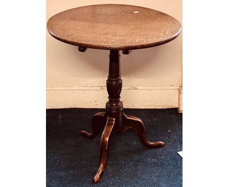 A George III mahogany circular tilt top table, turned column on tripod legs.