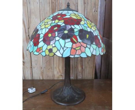 A Tiffany style table lamp with naturalistic base. 64 cm tall.&nbsp;