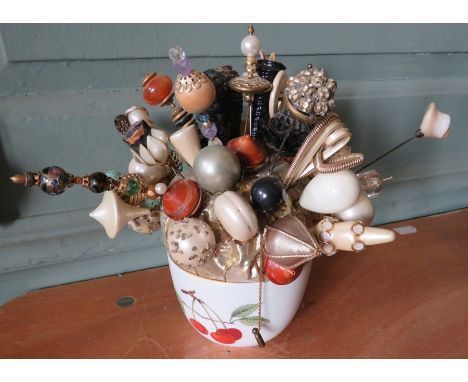 A hatpin collection in ceramic bowl.&nbsp;