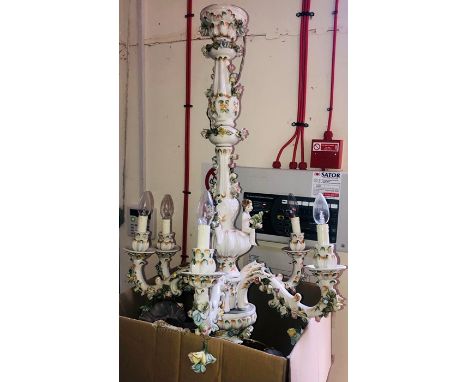 A 20th century porcelain five branch chandelier, encrusted with roses and cherubs. 69cm diameter