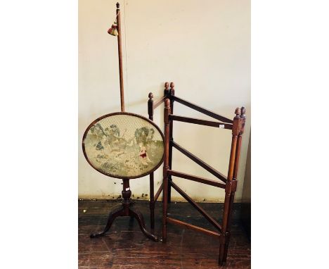 A Victorian mahogany polescreen, circa 1880, oval frame with tapestry landscape of peasants working in the field, on a turned
