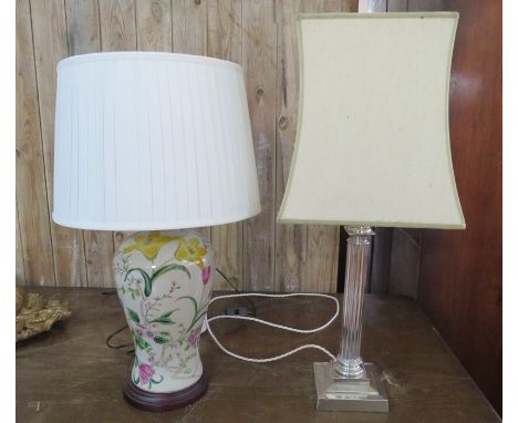 Two twentieth century table lamps - a ceramic example decorated with birds in colours, on wooden base Together with a silver-