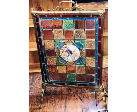 A 19th Century brass fire screen fitted with stained glass portrait of a robin. 87cm H