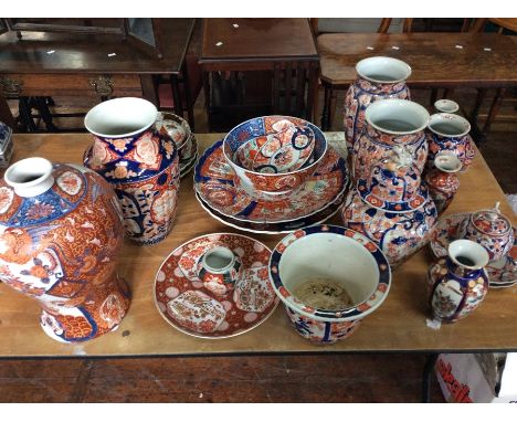 A collection of assorted 19th Century Japanese Imari ceramics, comprising a pair of large vases, a very large inverted balust