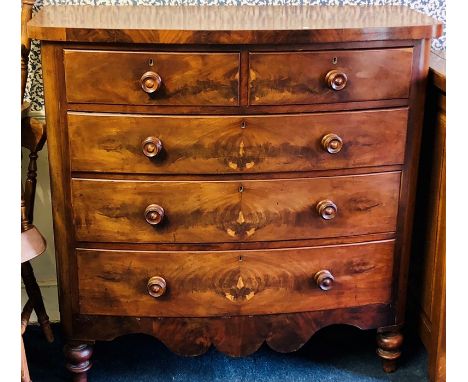 A Victorian flame mahogany bow front chest of drawers, circa 1880, slight oversailing top above two short and three long grad