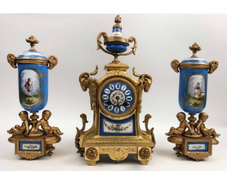 CLOCK SET, gilt ormolu and enamel, featuring rams heads and cherubs to bodys and romantic figures to enamel, 37cm H and 30cm 