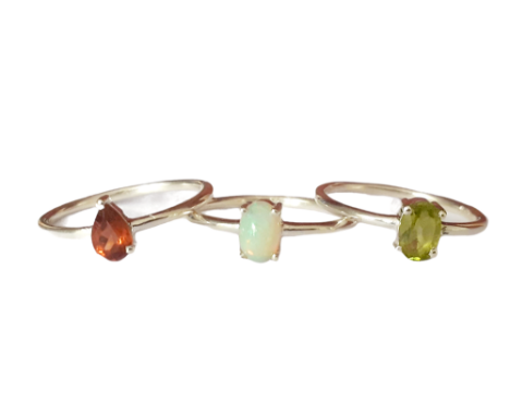 Three 925 silver stacking rings, set with peridot, garnet and opal, (M).