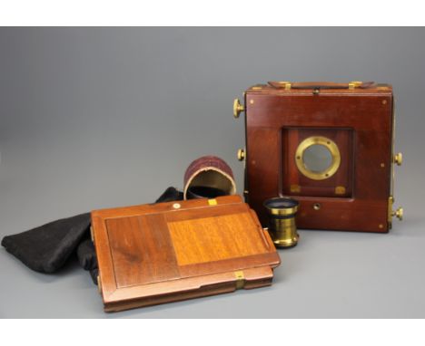 A Middlemiss of Bradford mahogany half plate camera with brass lens, in excellent condition with three dark slides.