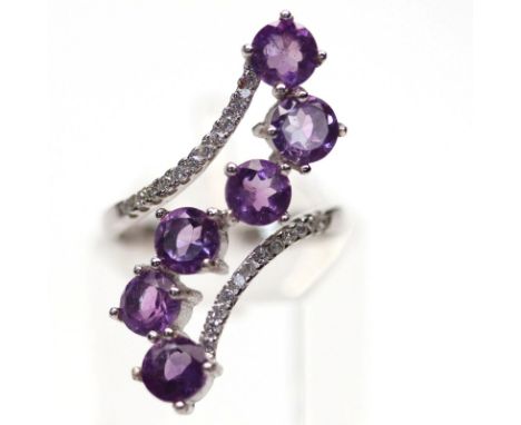 A 925 silver amethyst and white stone set crossover ring, (M).