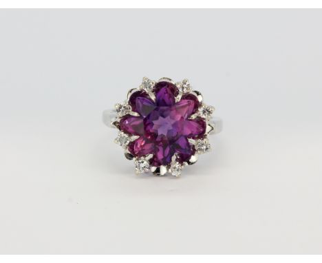 A 10ct white gold (stamped 10k) ring set with a large fancy cut amethyst and brilliant cut diamonds, (M), approx. 5.4gr.&nbsp