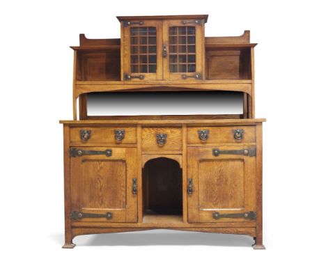 An Arts & Crafts oak sideboard,  c.1905,The upper section with a projected cornice, two astragal glazed doors enclosing a sin