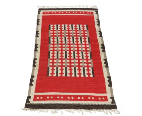 A Swedish flatweave wool kilim,c.1960/70, The ruby coloured field with black, white and grey geometric motifs, with conformin