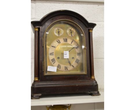 A mahogany mantle clock.