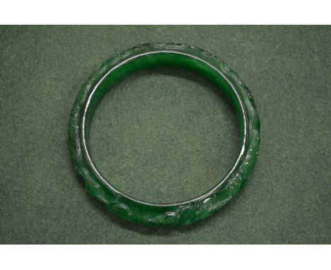 A carved jade bangle.
