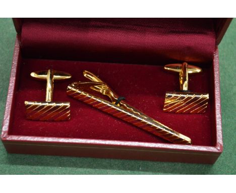 A cufflink and tie set.