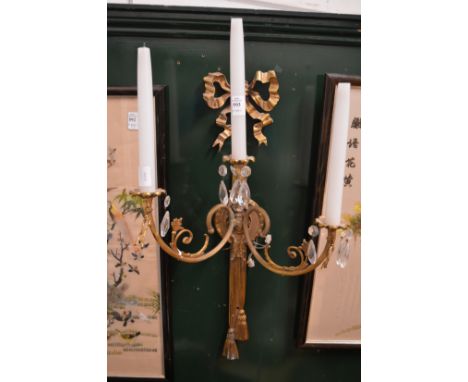 An ormolu and cut glass three light wall sconce.