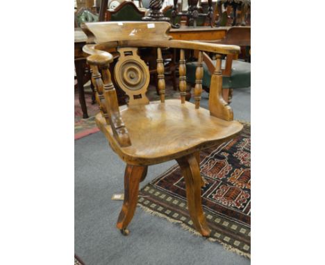 A 19th century elm spindle back revolving desk chair.
