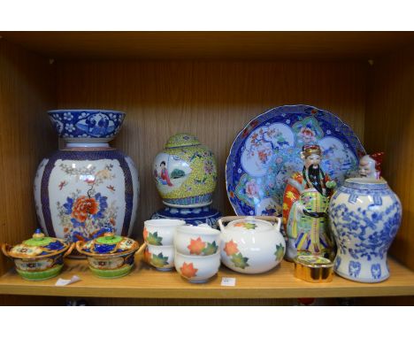 A shelf of oriental ceramics.