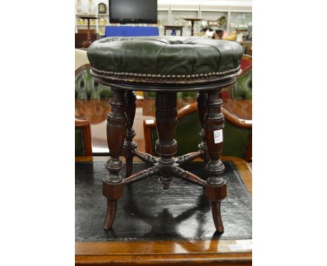 A 19th century green leather button upholstered revolving music seat.