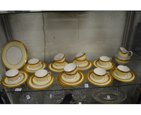 A Royal Worcester gilt and cream decorated part service comprising numerous cups, saucers, side plates, a pair of cake plates