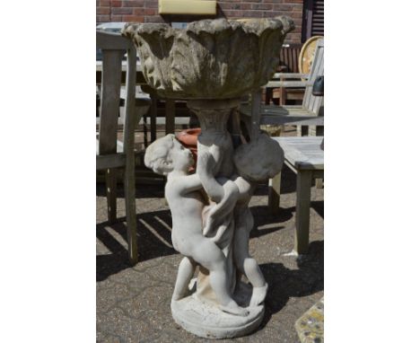A large pedestal garden planter the base modelled as two cherubs.