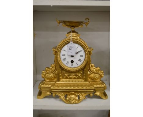A gilt metal mantle clock.