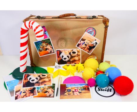 Steiff - A Steiff point of sale shop display - A vintage style suitcase covered in stickers and measuring 57 x 37 x 17 cm and