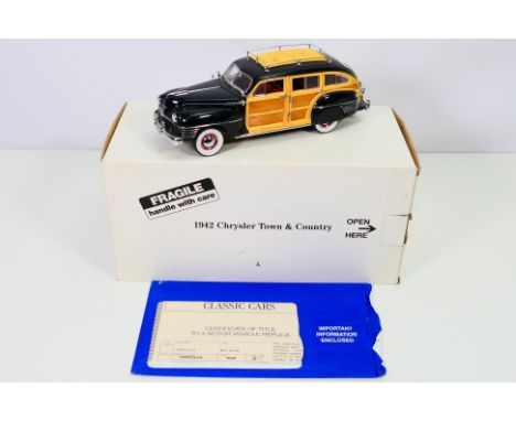 Danbury Mint - A boxed 1942 Chrysler Town & Country Woody Wagon in 1:24 scale. The model appears Mint in its original box wit