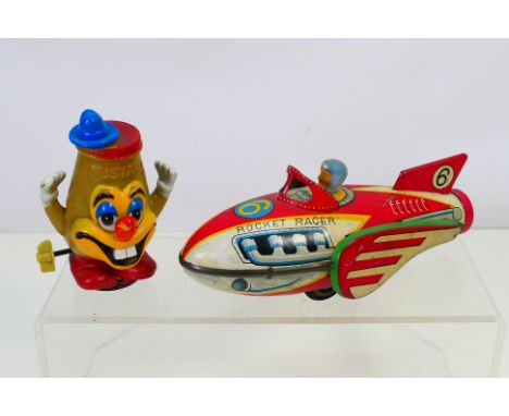 Marx - A clockwork Mustard Pot character by Louis Marx dated 1970 and in working order and a tinplate flywheel powered Rocket