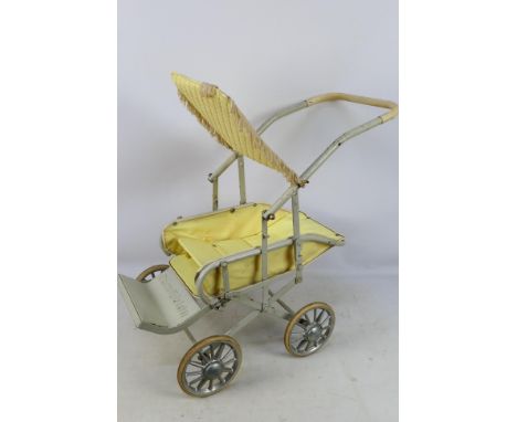 A vintage Cumfifolda dolls folding pushchair in yellow. [W] 