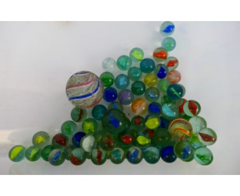Marbles - A quantity of vintage marbles. All show play wear with conditions generally Fair - Good. Marbles weigh approximatel