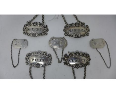 A collection of seven silver decanter labels for Sherry, Port, Madeira, Claret, Whisky and Brandy, various dates and makers, 