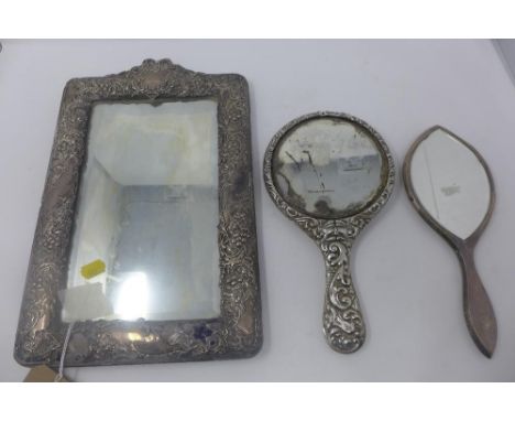 A Victorian white metal mounted easel mirror, decorated with scrolling foliage, vacant cartouche and bow finial, together wit