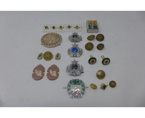 A collection of Persian Pahlavi era items, to include officers buttons, hat badges, a commemorative match box, and others (qt