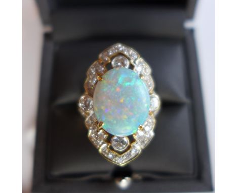 A Ladies yellow metal, probably 18ct gold, ring of Art Deco design having central opal and surrounded by brilliant cut diamon