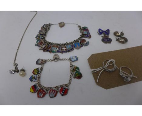 A collection of silver, to include two silver travel enamel shield charm bracelets, having padlock clasps, approx. 74g, a pai
