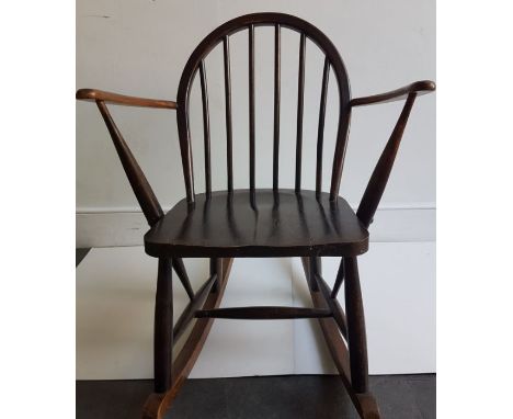 A dark stained Ercol child's rocking chair 
