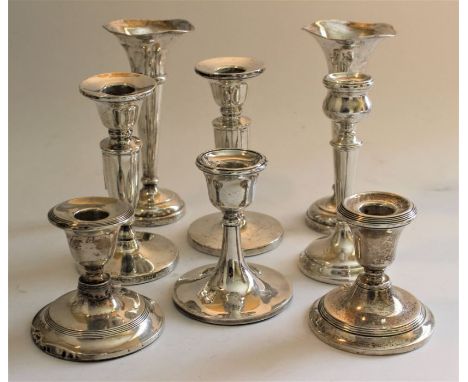 A pair of silver bud vases with shaped rims, circular bases, Birmingham 1976, 15cm high, a pair of silver baluster candlestic