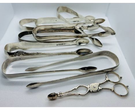 A selection of 18th and 19th century sugar tongs, along with a pair of tea tongs. The tea tongs have reversed c scroll arms a