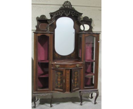 A late Victorian carved walnut mirror back Display Cabinet, the carved and pierced decorated cornice over a central shield sh