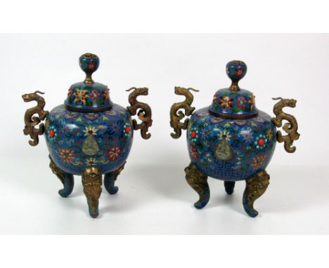 A pair of attractive 19th Century Chinese cloisonné and brass mounted tripod Urns with covers, the overall bulbous body decor