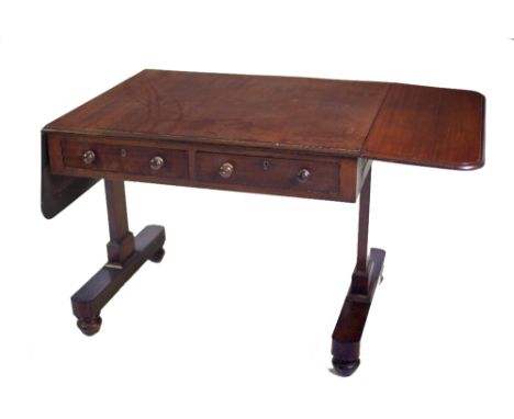 A 19th Century Irish mahogany Sofa Table, the plain top with drop ends, and two frieze drawers on straight T shape legs on bu