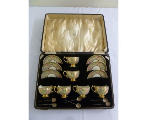 A cased set of six porcelain coffee cups and saucers with six silver coffee spoons, A/F