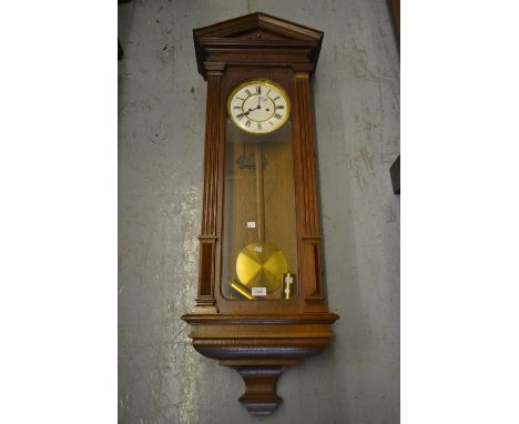 Late 19th or early 20th Century oak cased Vienna wall clock, the enamel dial with Roman numerals, the two train weight driven